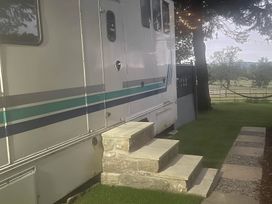 A horse box with stone steps and grass at Dobbin the horse box in The Lake District Cockermouth