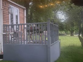 A deck area with a table and chairs at Dobbin the horse box in The Lake District Cockermouth