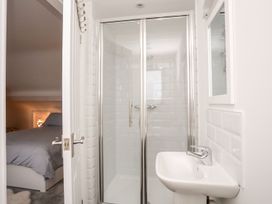 A bathroom with a shower and sink at Rhiwlas, Rhosneigr