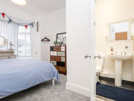 A bedroom with a bed and attached bathroom at Rhiwlas Rhosneigr