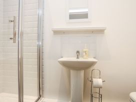 A bathroom with a shower and sink at Rhiwlas in Rhosneigr