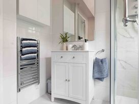 A bathroom with a sink and towel rack at Cotswolds Cozy Cottage Retreat - pet friendly, Finstock
