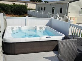 A hot tub on a deck at Tranquil Lodge Retreat in Paignton