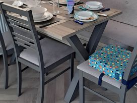 A dining table set with plates and glasses at Tranquil Lodge Retreat in Paignton