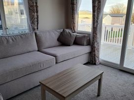 A living room with a sofa and coffee table at Tranquil Lodge Retreat in Paignton