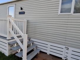 Steps leading to door with a sign at Lochwood in 