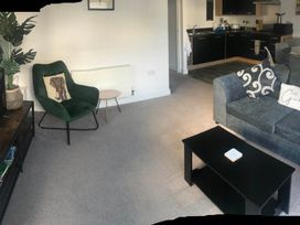 A living room with a sofa and an armchair at 2-Bed Apartment Sleeps 4 with Garden