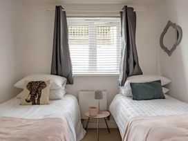 A bedroom with two beds and a window at 2-Bed Apartment Sleeps 4 with Garden