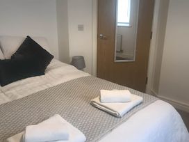 A bedroom with a bed and towels on it at 2-Bed Apartment Sleeps 4 with Garden