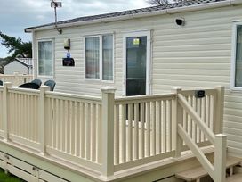 An outdoor view of a static caravan with a deck and steps at Beautiful Static Caravan Hoburne Devon Bay