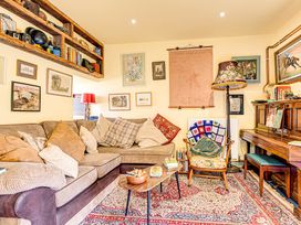 A living room with a sofa, table, and lamp at Family Country Cottage with a private Valley View
