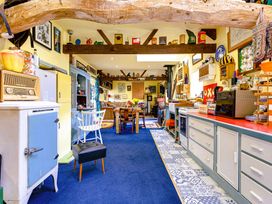 A kitchen with furniture and various decorations at Family Country Cottage with a private Valley View
