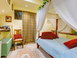 A bedroom with a bed and seating area at Family Country Cottage with a private Valley View