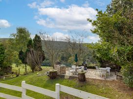 An outdoor area with seating and a grill at Family Country Cottage with a private Valley View