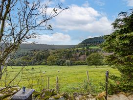 A view of a field with sheep and trees at Family Country Cottage with a private Valley View
