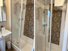 A bathroom with a shower and sink at Static Caravan Hoburne Devon Bay