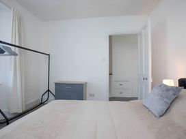 A bedroom with a bed, wardrobe and lamp at Torquay - House - Sleeps 6 - Pet Friendly