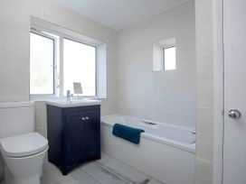 A bathroom with a toilet, sink, and bathtub at Torquay - House - Sleeps 6 - Pet Friendly