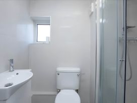 A bathroom with a sink, toilet, and shower at Torquay - House - Sleeps 6 - Pet Friendly