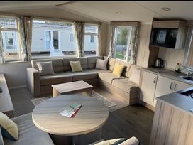 A living room with a sofa and coffee table at Beverley bay 2-Bed Caravan, Sleeps 6, Pet Friendly