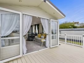 A living room area with sofa and dining table at Blue water 3 Beverley Bay Static Caravan in Paignton