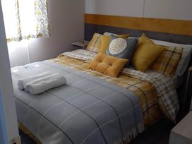 A bedroom with a bed and bedside table at Blue water 3 Beverley Bay Static Caravan Paignton