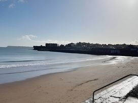 A beach with sand and calm water at Blue water 3 Beverley Bay Static Caravan Paignton