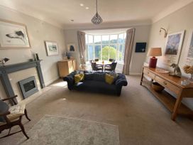 A living room with a fireplace and sofa at Beachside 2-Bed - Sleeps 4, Parking & Pet Friendly, Salcombe