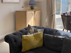 A living room with a sofa and cushions at Beachside 2-Bed - Sleeps 4, Parking & Pet Friendly, Salcombe