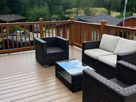 An outdoor area with wicker furniture and a table at 2 Bed Lodge-Sleeps 4-stunning views -Pet Friendly, Troutbeck
