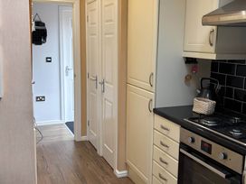 A kitchen with an oven and cabinets at 2 Bed Lodge-Sleeps 4-stunning views -Pet Friendly, Troutbeck