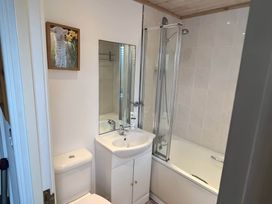 A bathroom with a shower, sink, and toilet at 2 Bed Lodge-Sleeps 4-stunning views -Pet Friendly, Troutbeck