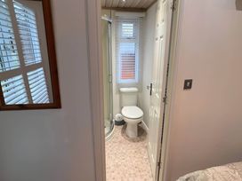 A bathroom with a toilet and shower at 2 Bed Lodge-Sleeps 4-stunning views -Pet Friendly, Troutbeck