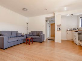 A living room with sofas and kitchen appliances at Luxury 2 Bed Room Lake View Apt Bowness Parking Bowness-On-Windermere