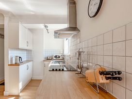 A kitchen with cabinets, a counter, and appliances at Luxury 2 Bed Room Lake View Apt Bowness Parking Bowness-On-Windermere