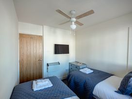 A bedroom with two beds and a television at Luxury 2 Bed Room Lake View Apt Bowness Parking Bowness-On-Windermere