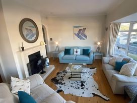 A living room with a fireplace and sofas at 4 Bed House-Sleeps 8-Parking-Pets-MarinaSeaView in Torquay