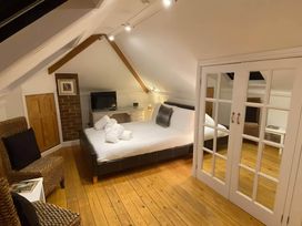 A bedroom with a bed and television at 4 Bed House-Sleeps 8-Parking-Pets-MarinaSeaView in Torquay