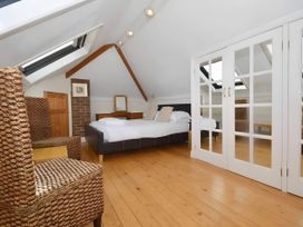 A bedroom with a bed and chairs at 4 Bed House-Sleeps 8-Parking-Pets-MarinaSeaView in Torquay