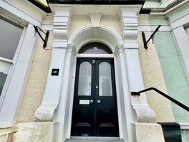 An entrance with a black door and number 3 at Sea View, East Parade in Llandudno
