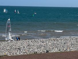 People near a sailing boat on a beach by the ocean at Sea View, East Parade Llandudno