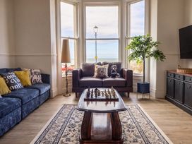 A living room with a chess set on a table at Sea View, East Parade, Llandudno