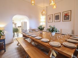 A dining room with a table set for dinner at Sea View, East Parade, Llandudno