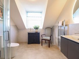 A bathroom with a sink, toilet, and vanity at Sea View, East Parade, Llandudno