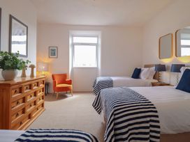 A bedroom with two beds and a dresser at Sea View, East Parade in Llandudno