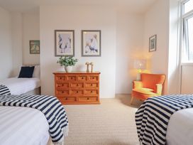 A bedroom with two beds and a dresser at Sea View, East Parade in Llandudno