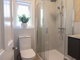 A bathroom with a toilet and shower at Sea View, East Parade, Llandudno