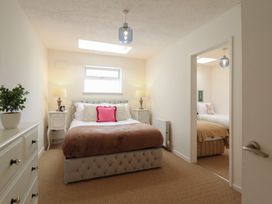 A bedroom with a bed and nightstands at Sea View, East Parade in Llandudno