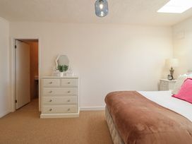 A bedroom with a bed and a dressing table at Sea View, East Parade in Llandudno