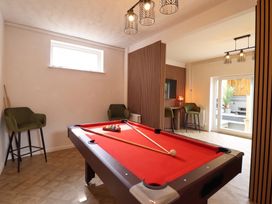 A game room with a pool table and chairs at Sea View, East Parade Llandudno